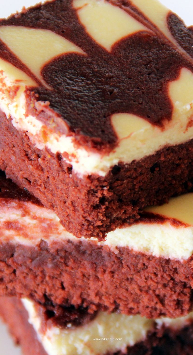 red velvet cheesecake swirl brownies in a stack