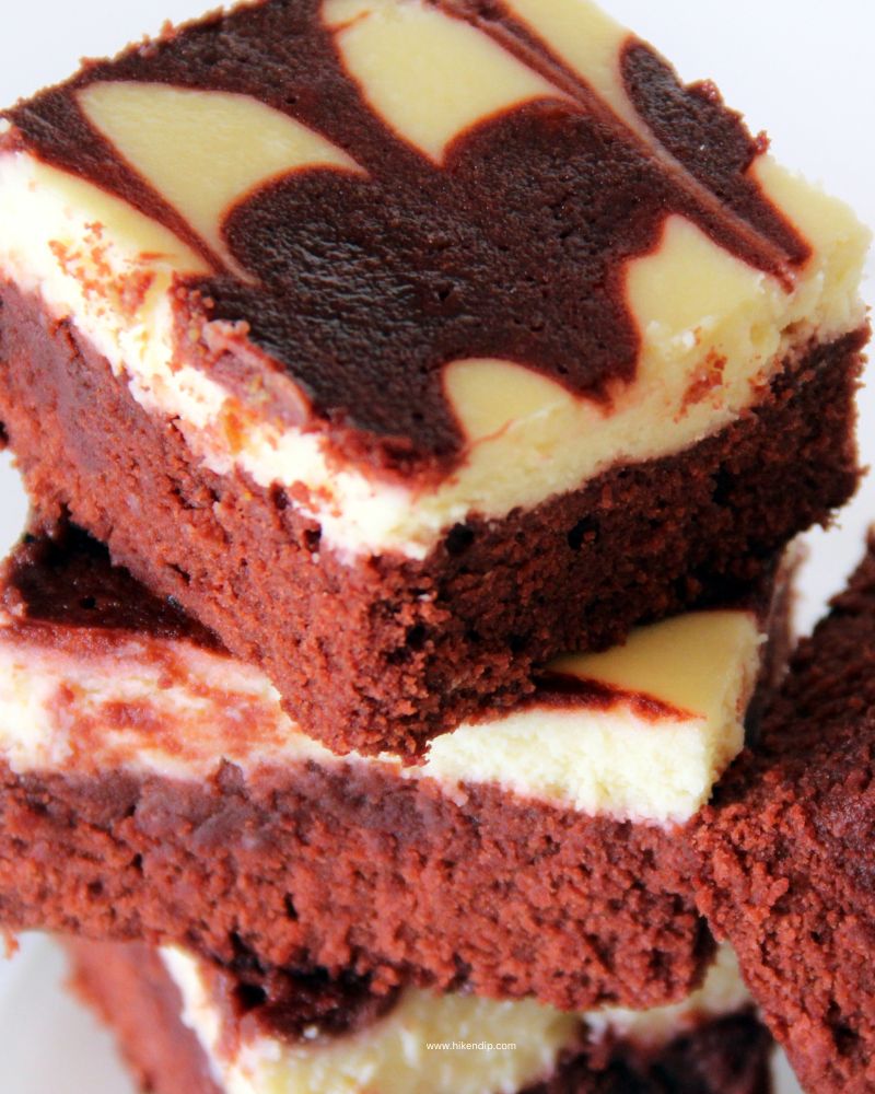 red velvet cheesecake swirl brownies in a stack