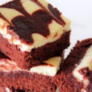 red velvet cheesecake swirl brownies in a stack