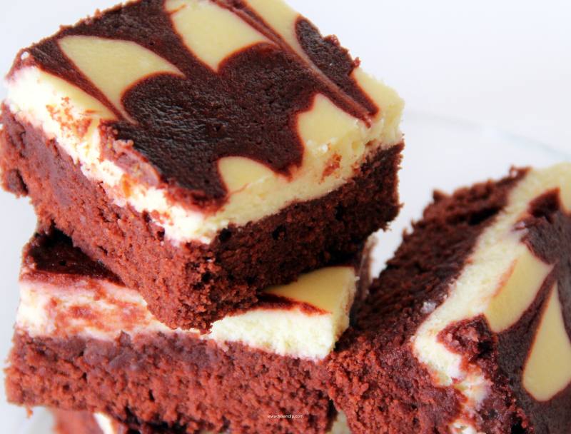 red velvet cheesecake swirl brownies in a stack