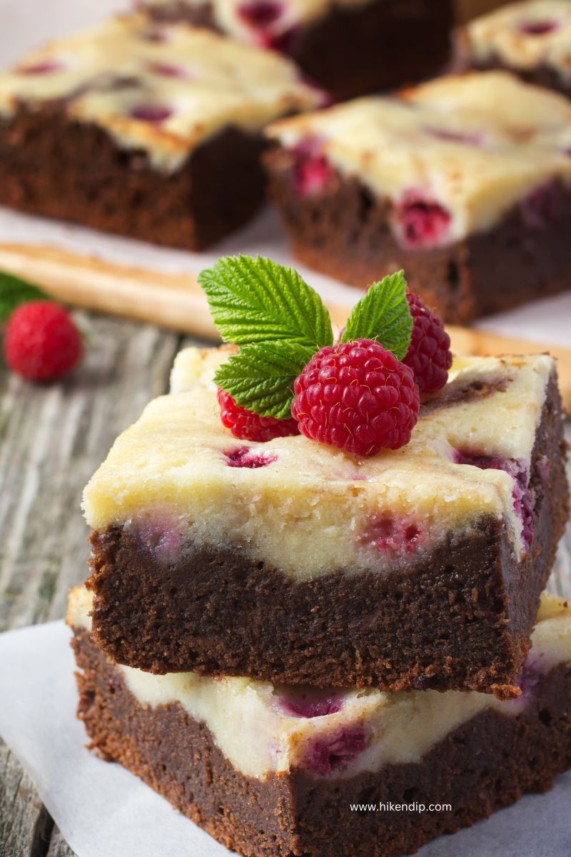 raspberry cheesecake swirl brownies on a parchment paper