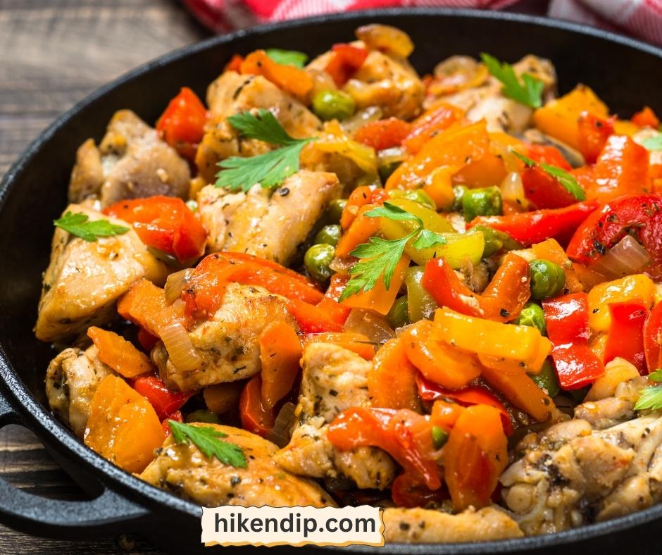 chicken in a skillet with vegetables